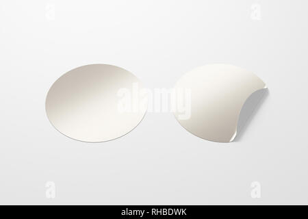Blank silver round stickers straightened and with folded corner on white background. With clipping path around stickers. Stock Photo