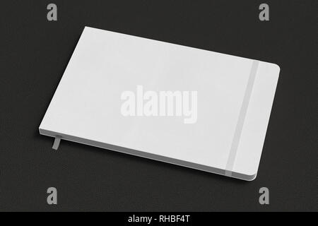 White horizontal notebook with elastic band on black background Stock Photo