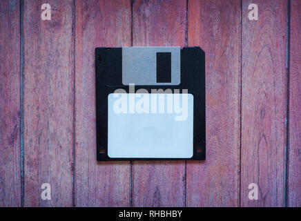 Antique pc diskettes on a brown wooden background Stock Photo