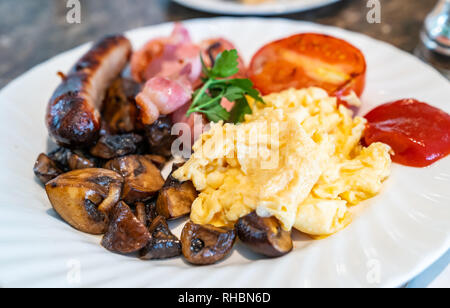 Full English Breakfast on Table with coffee Stock Photo