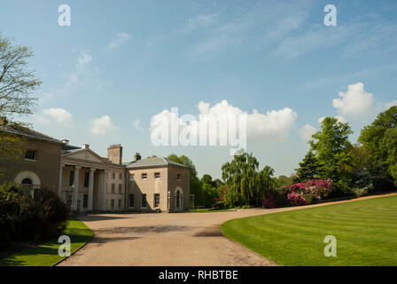 The grounds of Kenwood House with lawns, distant azaleas, on a beautiful sunny spring day, with blue skies and fluffy white clouds.lawn