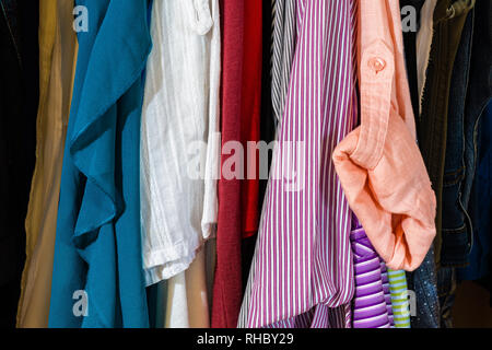 Close up on women's clothes hanging in closet/wardrobe Stock Photo