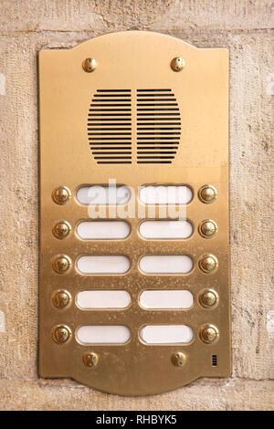 Brass intercom on a marble facade Stock Photo