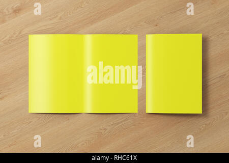 Blank yellow half-folded flyer leaflet on wooden background. With clipping path around brochure Stock Photo