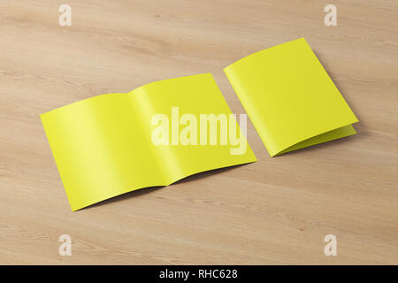Blank yellow half-folded flyer leaflet on wooden background. With clipping path around brochure Stock Photo