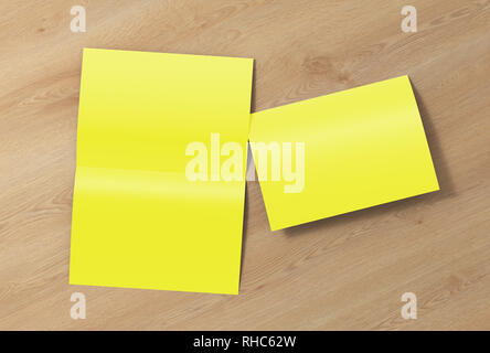 Blank yellow open and folded half-folded flyer leaflet on wooden background. With clipping path around brochure Stock Photo