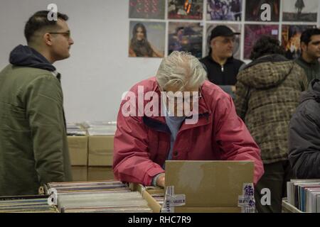 A man seen searching for vinyl during the event. Vinyl Market is a festival with many new disc collections, many collectibles and new releases. It also has collections of other music themes, CDs, Posters, music magazines, books and many other related exhibits. Stock Photo