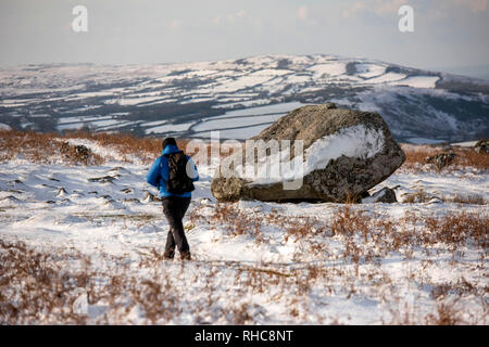 Swansea, UK. 01st Feb, 2019. A lone hiker walks past King Arthurs Stone on the top of Cefn Bryn near Reynoldston on the Gower Peninsula near Swansea this afternoon after the area was blanketed with snow. Credit: Phil Rees/Alamy Live News Stock Photo