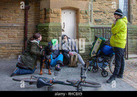 Blackpool, Lancashire, UK. 1st February, 2019. UK Weather: Cold day in Blackpool as recently evicted people gather at St Johns Church to see if the church will offer accommodation overnight.  The church will admit rough sleepers if the temperature falls below freezing and then only to under 25's.  Unit the decision is made homeless people gather outisde waiting for the decision. Credit: MediaWorldImages/Alamy Live News Stock Photo
