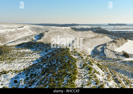 Maiden Castle, Dorchester, Dorset, UK. 2nd Feb, 2019.  UK Weather. A wintry view of the iron age hill fort of Maiden Castle near Dorchester in Dorset as the snow begins to thaw on a clear sunny morning as the temperatures begin to rise. Picture Credit: Graham Hunt/Alamy Live News Stock Photo