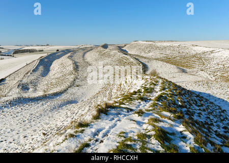 Maiden Castle, Dorchester, Dorset, UK. 2nd Feb, 2019.  UK Weather. A wintry view of the iron age hill fort of Maiden Castle near Dorchester in Dorset as the snow begins to thaw on a clear sunny morning as the temperatures begin to rise. Picture Credit: Graham Hunt/Alamy Live News Stock Photo