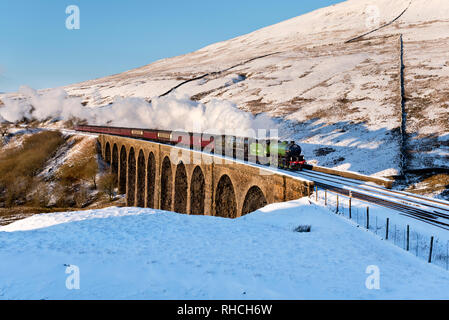 Dentdale, Yorkshire Dales. 2nd February 2019. The Winter Cumbrian Mountain Express crosses Arten Gill Viaduct on the famous Settle-Carlisle railway line in snowy Dentdale, Yorkshire Dales National Park, UK. The special train is hauled by double-headed locomotives 'British India Line' and 'Mayflower'. Double-headed steam trains on the mainline are very rare and this is an unusual combination of locomotives. Credit: John Bentley/Alamy Live News Stock Photo