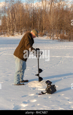 Man using ice auger hi-res stock photography and images - Alamy
