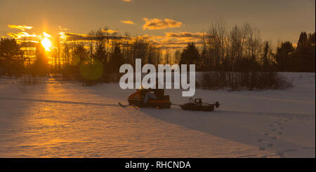 Man pulling sled with ice fishing gear, Wyoming, USA Stock Photo - Alamy