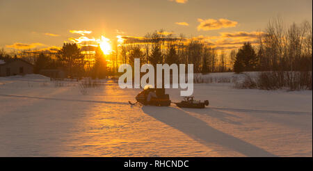 Man pulling sled with ice fishing gear, Wyoming, USA Stock Photo - Alamy