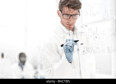 scientist making notes on the glass Board at the time of the experiment Stock Photo