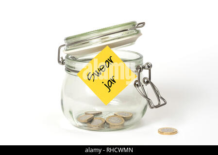 Swear jar. Glass food jar isolated on white background filled with coins and sticky note on outside Stock Photo