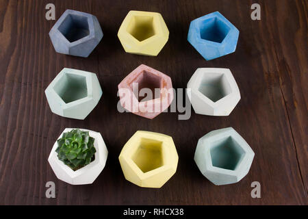 top view succulent and empty concrete pots for plants on a wooden background,  example of design and products for interior decoration Stock Photo