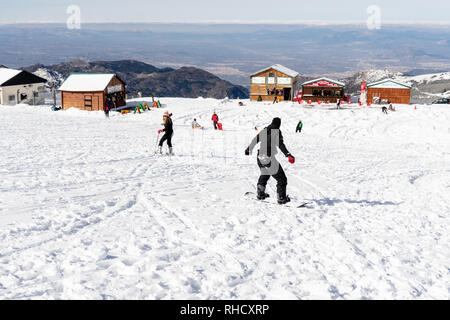 People having fun doing winter sports in Sierra Nevada. Stock Photo