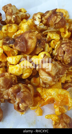 Caramel-flavored popcorn snacks on a tissue at the table Stock Photo