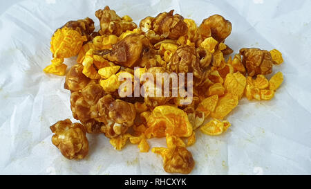 Caramel-flavored popcorn snacks on a tissue at the table Stock Photo