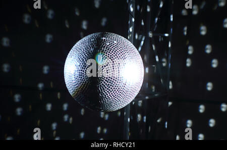 Lights reflections on the ceiling from shining mirror ball at the disco Stock Photo
