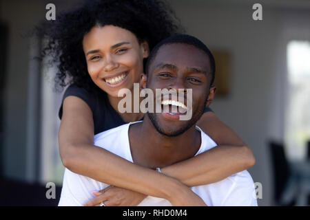Happy millennial black couple laughing having fun outdoors, portrait Stock Photo