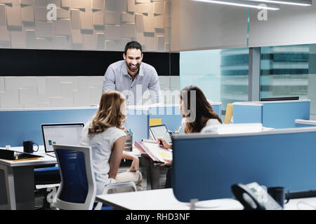 Portrait Of Happy Businessman Smiling In Coworking With Colleagues Stock Photo