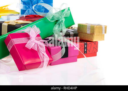 pile of colorful gift boxes over white with reflection Stock Photo