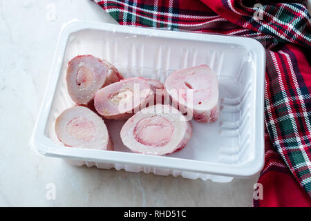 Raw Frozen Veal Bones in Container / Plastic Box Package. Organic Food. Stock Photo