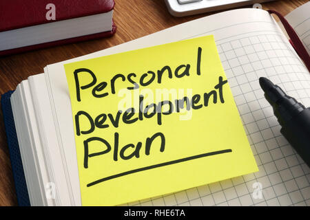 Personal development plan. Memo stick in the notepad. Stock Photo