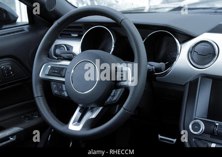 Look on steering wheel, dashboard and leather stitched interior of a car Stock Photo