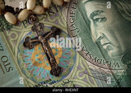 Catholic cross on a background of money / concept Stock Photo