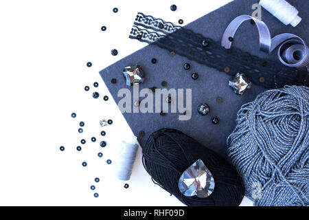 A set of materials for needlework in grey color on a white background. Stock Photo