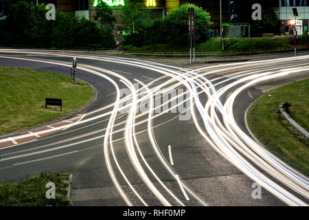 Crisscrossing light trails from cars on a roundabout in Bournemouth, England Stock Photo