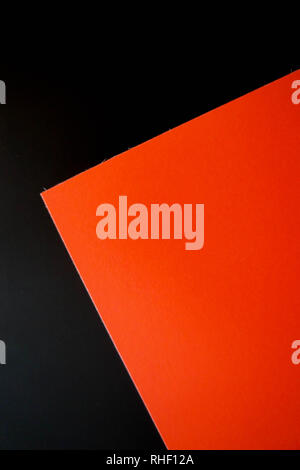 Dark flat lay background with color paper sheets. Black and red. Stock Photo