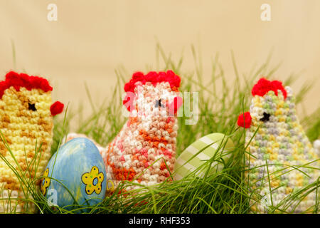 chickens in easter nest of grass with eastereggs Stock Photo