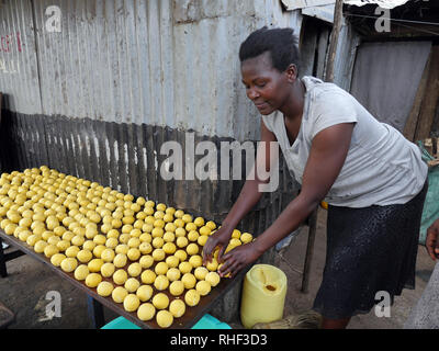 KENYA  -   photo by Sean Sprague  Visiting 'Mary' who is HIV+, here making donuts, her business. Stock Photo