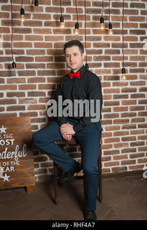 A man in classic clothes. The man in the interior. Picture. Stock Photo