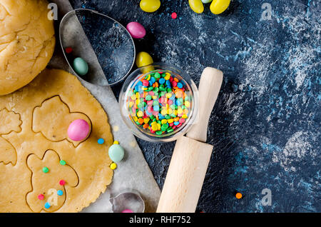 Happy Easter card. Easter biscuits,  cuttings, candy eggs and ingredients for baking rolled dough dough Stock Photo