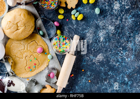 Happy Easter card. Easter biscuits,  cuttings, candy eggs and ingredients for baking rolled dough dough Stock Photo