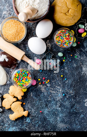 Happy Easter card. Easter biscuits,  cuttings, candy eggs and ingredients for baking rolled dough dough Stock Photo