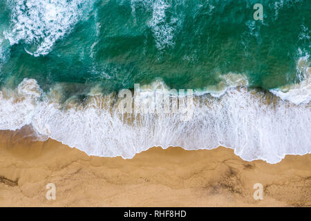 Top down view of the waves crashing onto the sand at Dudley Beach - Newcastle Australia Stock Photo