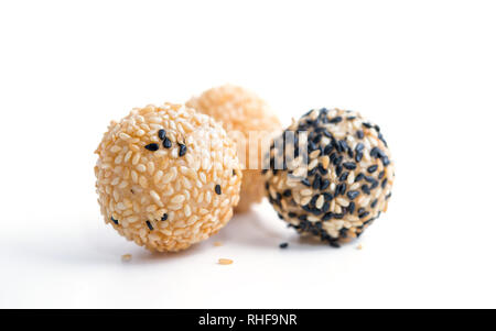 fried sesame dessert balls with paper bag on white background Stock Photo