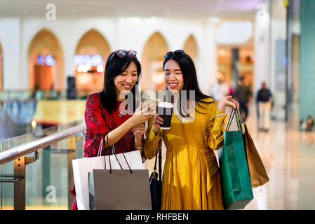 Asian girls doing shopping in the mall Stock Photo