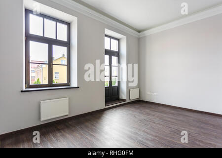 Side view of unfurnished room loft interior with wooden floor, white walls  with bright daylight Stock Photo
