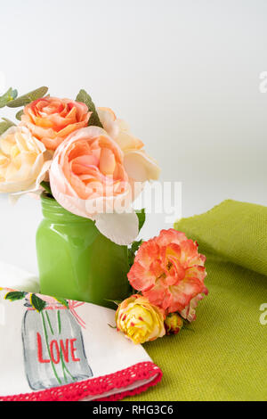 Valentine's Day cupcake in holiday paper with flowers in background