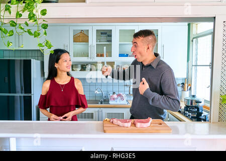 Lovely couple posing - man proud his self and young woman smiling at him Stock Photo