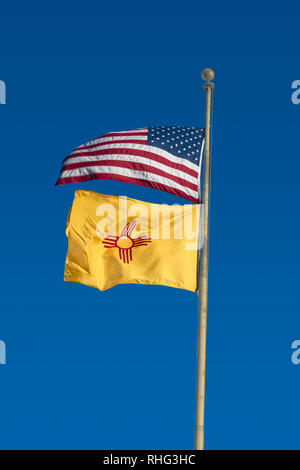 USA and New Mexico State Flag waving in the sky Stock Photo