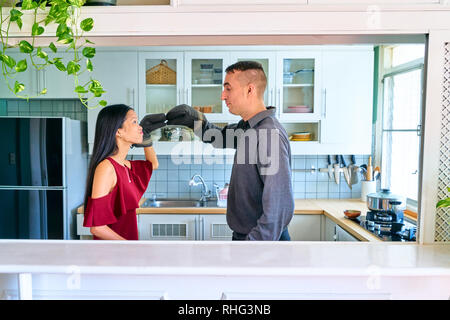 Lovely couple posing - playing the puppet hands and kissing Stock Photo